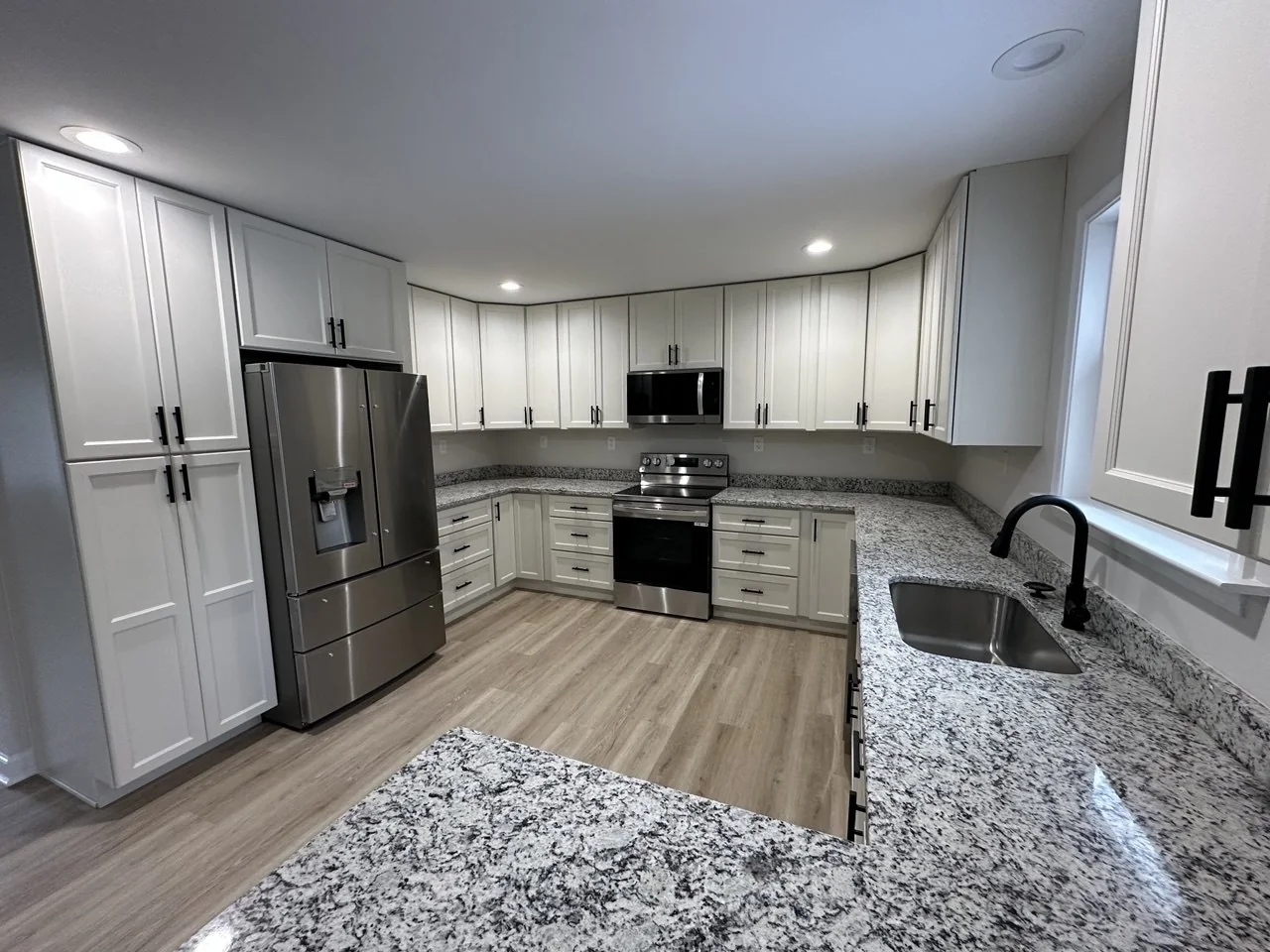 Bright custom kitchen with white cabinetry and a large island