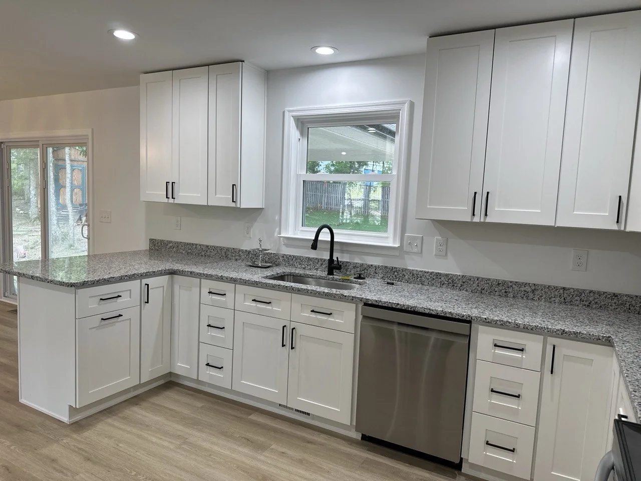 Light kitchen with natural wood flooring
